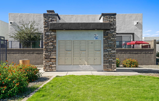 the front of a building with a garage door and a lawn