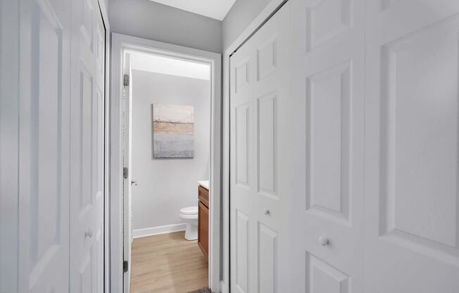 a bathroom with a toilet and a sink at Stonewater Apartments, Louisville