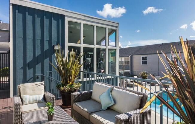 a patio with furniture and a pool in front of a house at Skyline Heights LLC, Daly City