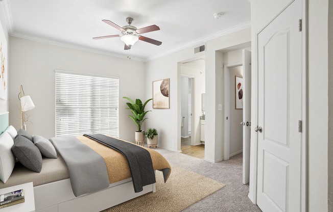 a bedroom with a bed and a ceiling fan at La Ventura Apartments, Texas, 75093