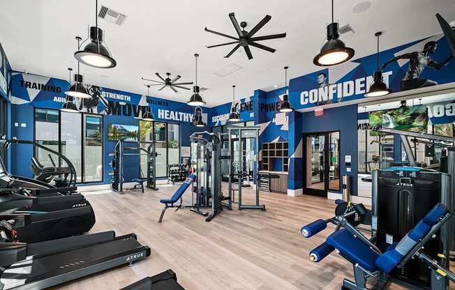 a gym with cardio machines and weights on a wooden floor at Altis Santa Barbara, Naples, 34104