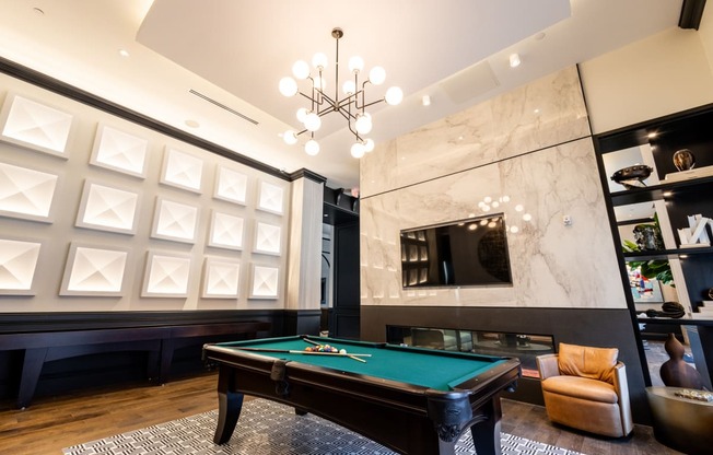 a game room with a pool table and a tv