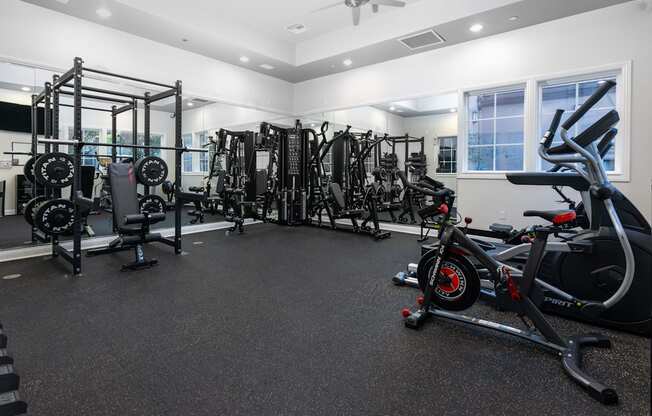 A spacious gym with a variety of equipment including treadmills, weights, and exercise machines.