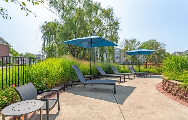 our patio has umbrellas and chairs and tables