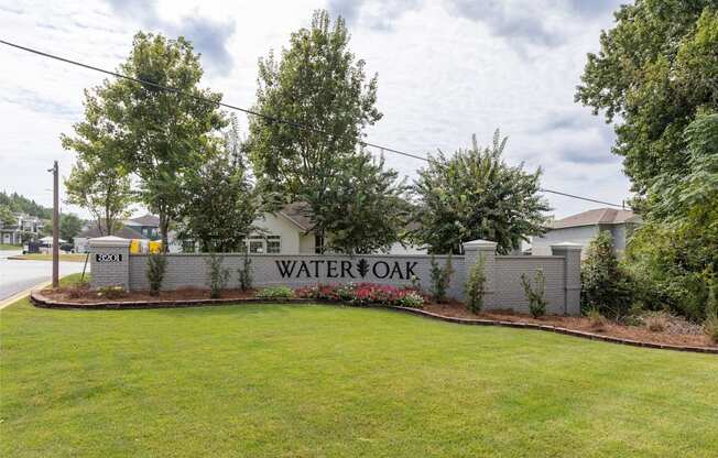 A sign that says "Watersoak" is in front of a grassy area.