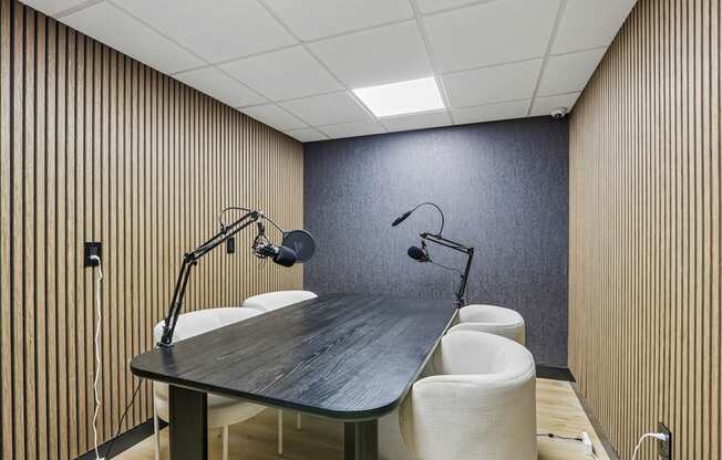 A conference room with a long table and chairs.