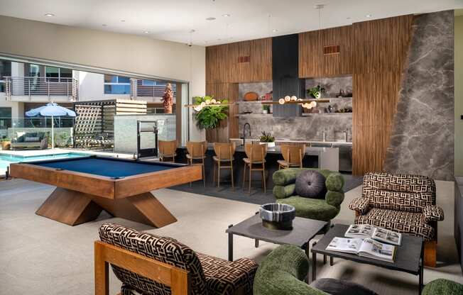a living room with a pool table and a dining table