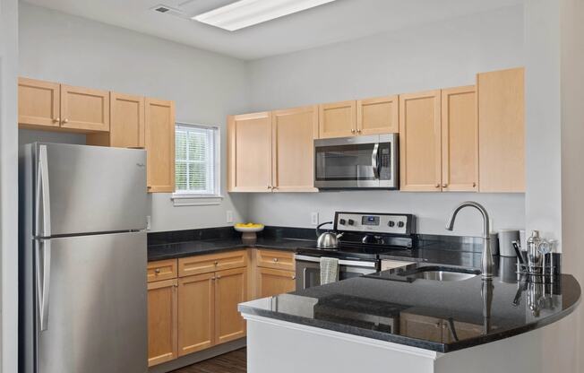 a kitchen with wooden cabinets and stainless steel appliances