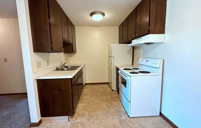 a kitchen with a sink and a refrigerator