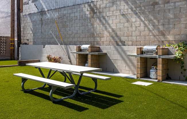 a picnic table and a bench in a backyard