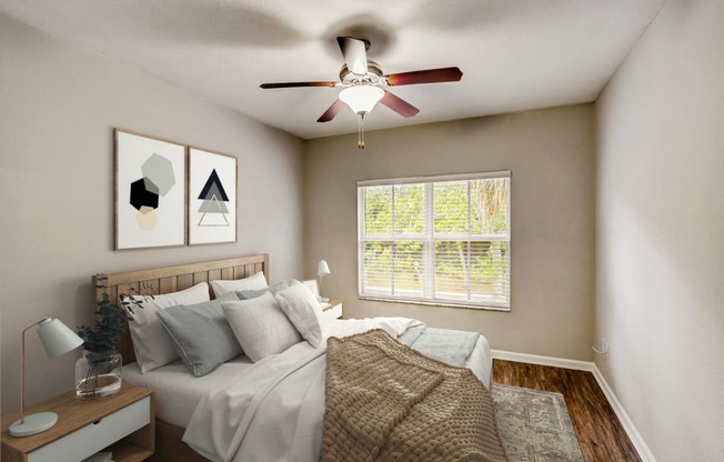 an empty bedroom with a ceiling fan and a bed
