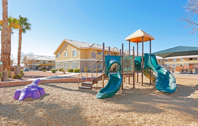 Apartments for Rent in North Las Vegas, NV - Portola Del Sol - Playground Area with Wood Chips, Slides, and Landscaping