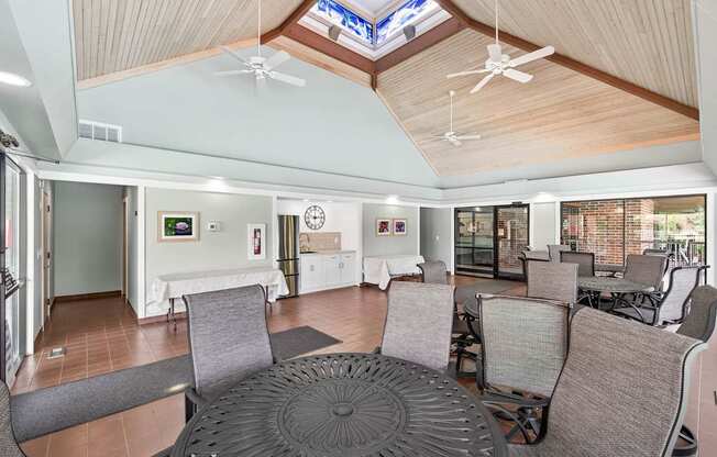 A large, open-plan living space with a skylight and a variety of seating options.