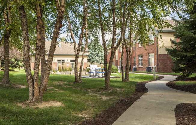 Scenic courtyard with mature trees and walking path at Southwind Villas in southwest Omaha in La Vista, NE, 68128