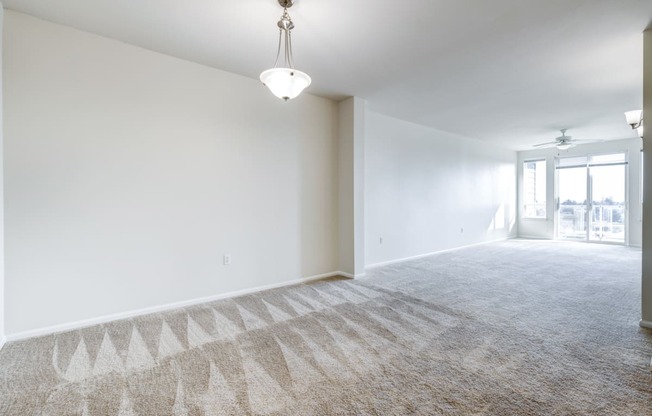 an empty living room with a chandelier