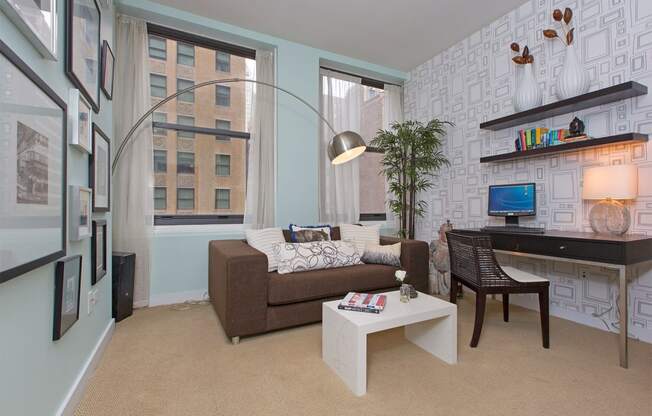 a living room with a couch and a desk