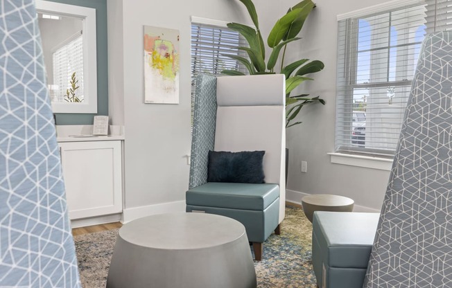 a living room with a chair and and other furniture and a window