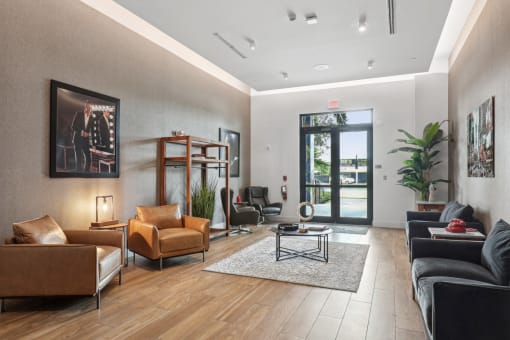 a living room with leather furniture and a door to a patio