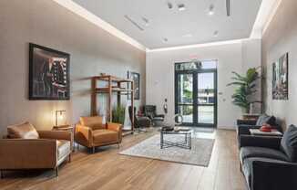 a living room with leather furniture and a door to a patio