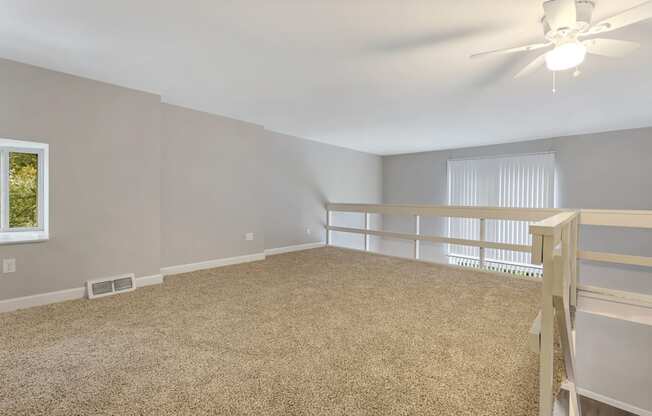 an empty room with a bunk bed and a ceiling fan