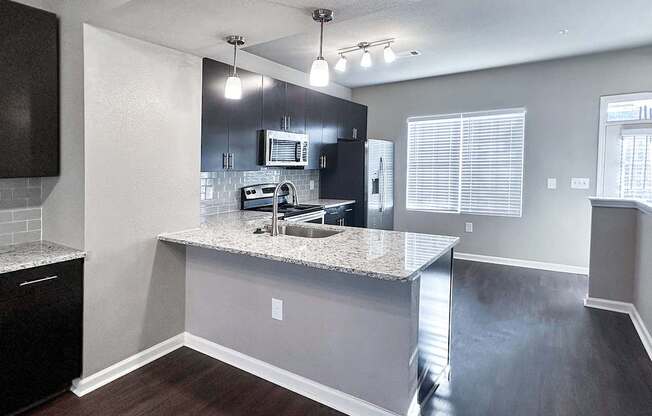 Townhome kitchen with granite countertops and stainless steel appliances