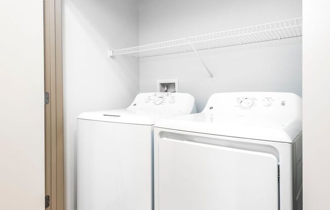a washer and dryer in a room with a door