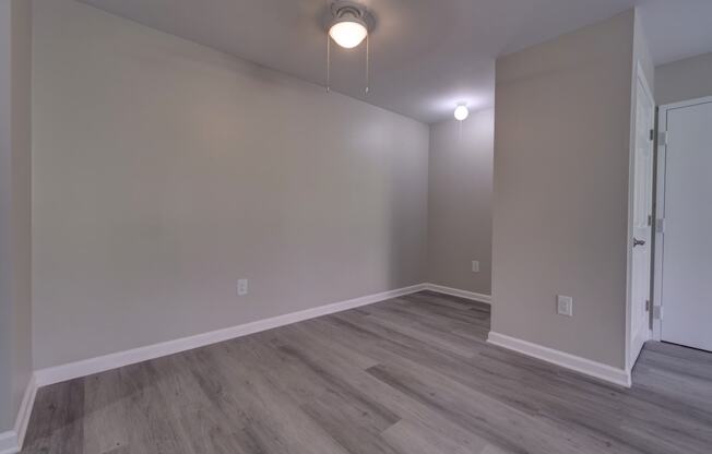 a bedroom with hardwood flooring at the whispering winds apartments in pearland, tx