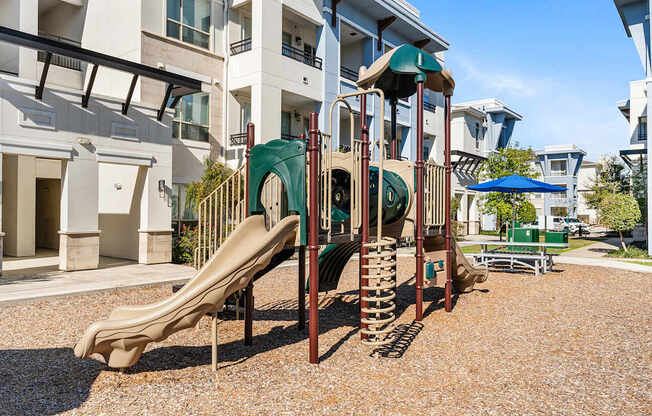 A playground with a slide and a climbing frame.