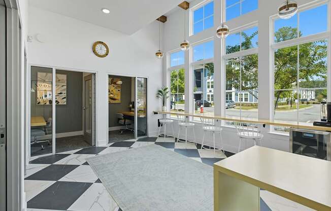A white and black checkered floor in a room with a large window.