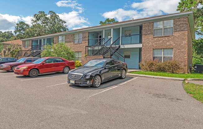 a car parked in a parking lot in front of an apartment building
