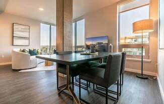 A modern dining room with a large table and chairs.