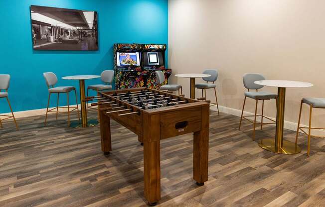 a game room with a foosball table and a video game