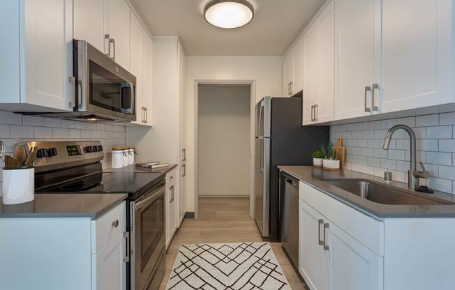 a kitchen with a sink and a refrigerator at Delphine on Diamond, San Francisco, CA