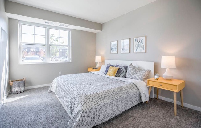Bedroom with large windows at Ascend at Woodbury new luxury apartments in Woodbury MN 55129