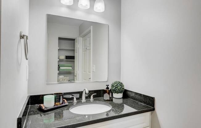 a white bathroom with a sink and a mirror
