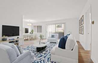 a living room with blue and white furniture and a tv