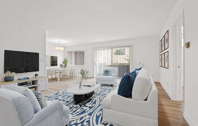 a living room with blue and white furniture and a tv