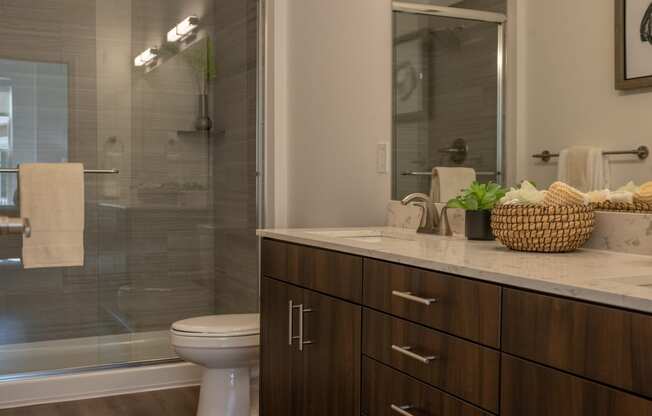 an image of a bathroom with a shower and a toilet  at The Clearing at ONE28, Olathe, Kansas