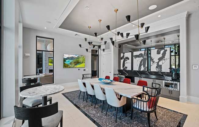 a dining room with a long table and chairs and a living room at Altis Grand Suncoast, Florida
