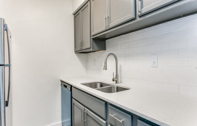 a kitchen with a sink and a refrigerator