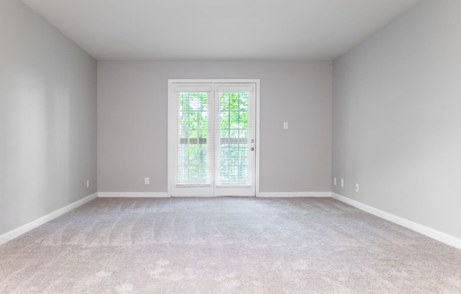 a bedroom with gray walls and a white carpet