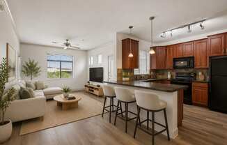 A modern kitchen with dark wood cabinets and a black refrigerator.