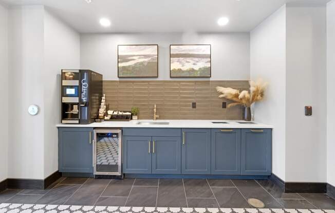 a kitchen with blue cabinets and a coffee machine