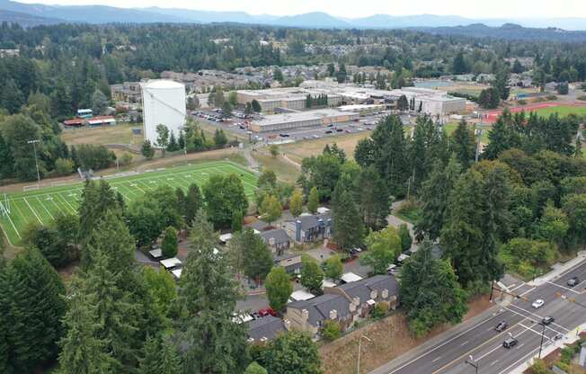 an aerial view of a city with trees and buildings