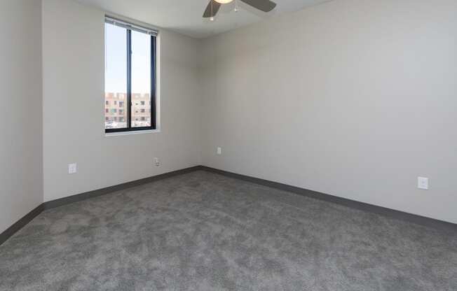 Spacious living room with neutral walls and ample natural light.