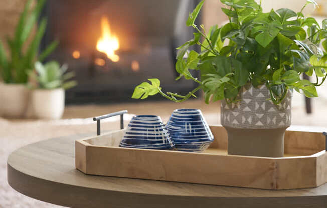 a living room with a coffee table and a fireplace at The Winhall of Williams Pointe Apartments, Waukee, 50263