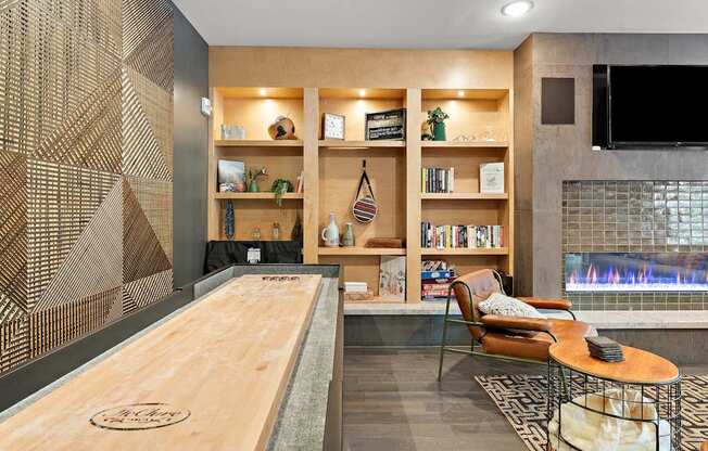 A modern living room with a fireplace and a shelving unit.