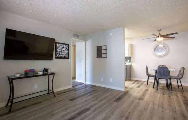 an open living room and dining room with a table and chairs