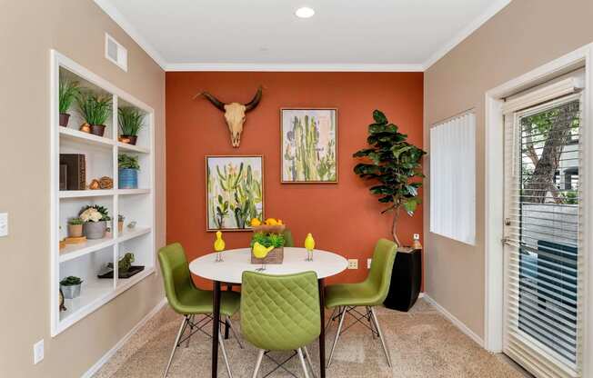 a dining room with a table and chairs      and a window