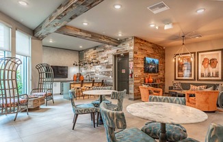 A living room with a stone wall and a television.